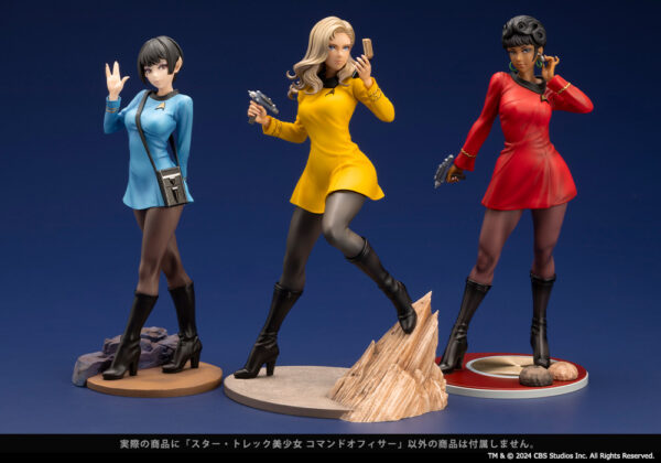 Three Star Trek: The Original Series Bishoujo statues featuring characters in different uniform colors, each holding a communicator or phaser. From left to right: a Vulcan science officer in a blue uniform, a command officer in a yellow uniform standing on a rocky base, and Uhura, the communications officer in a red uniform with a circular base. Each figure is styled in a dynamic pose, capturing the essence of their respective roles aboard the starship.